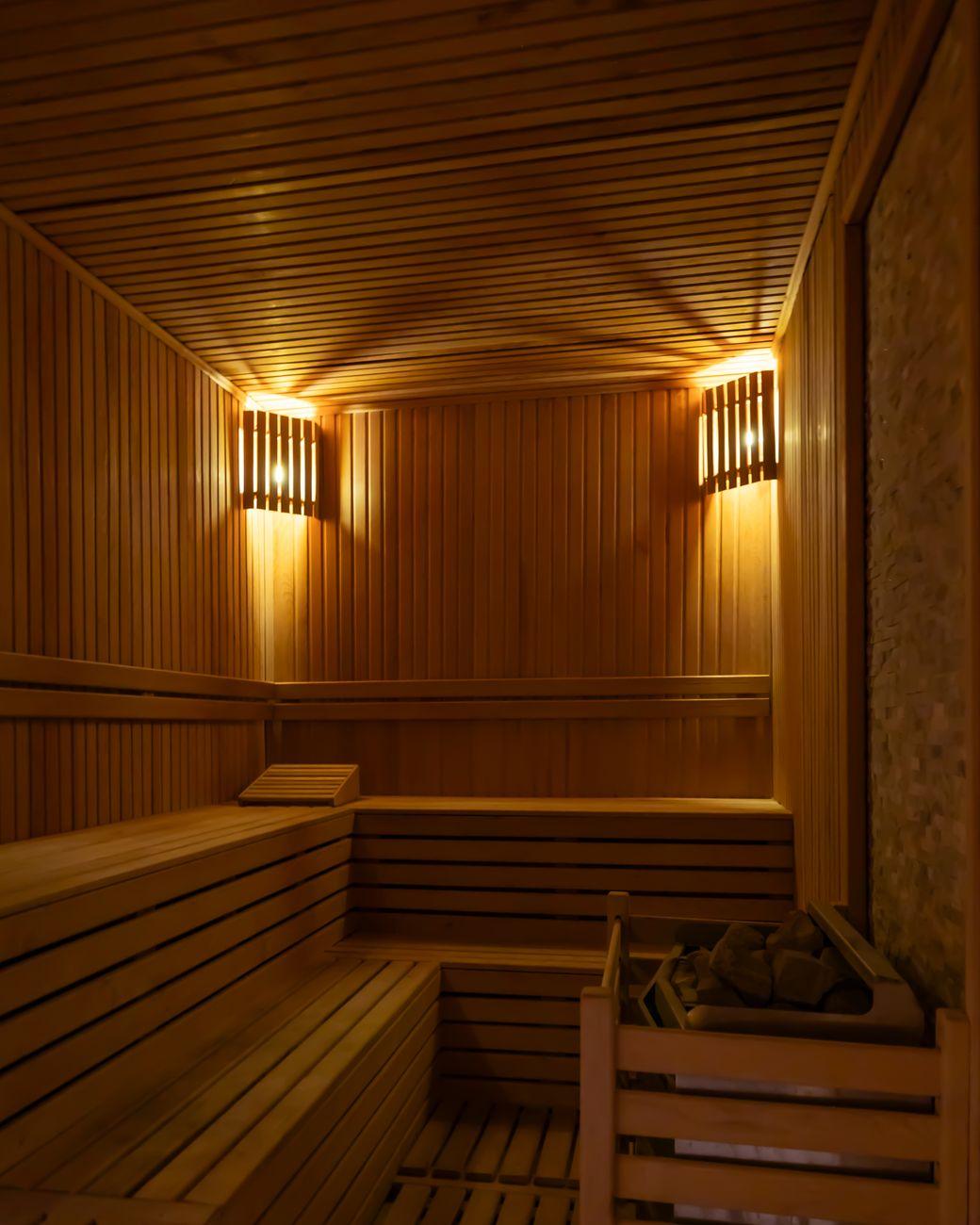 Warm cedar sauna glowing in low light